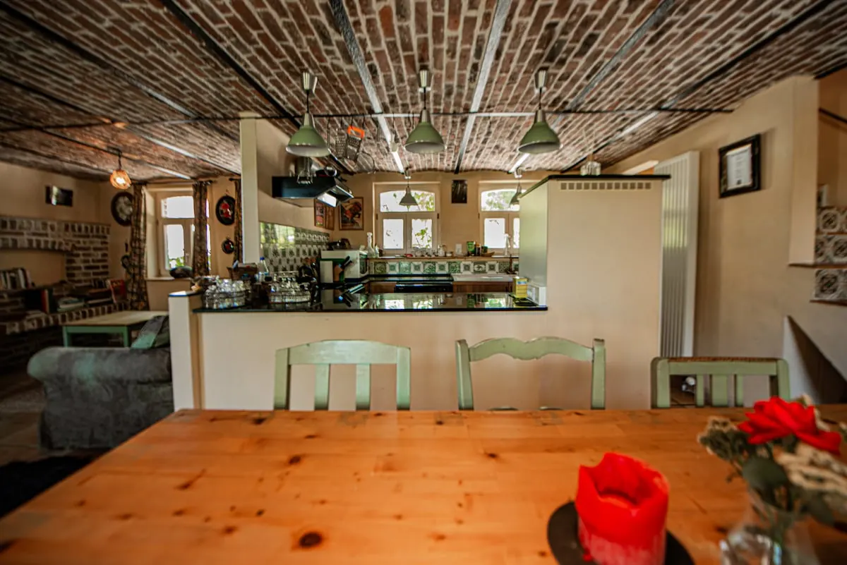 Kitchen and dining area at Les Plachettes in Flobecq